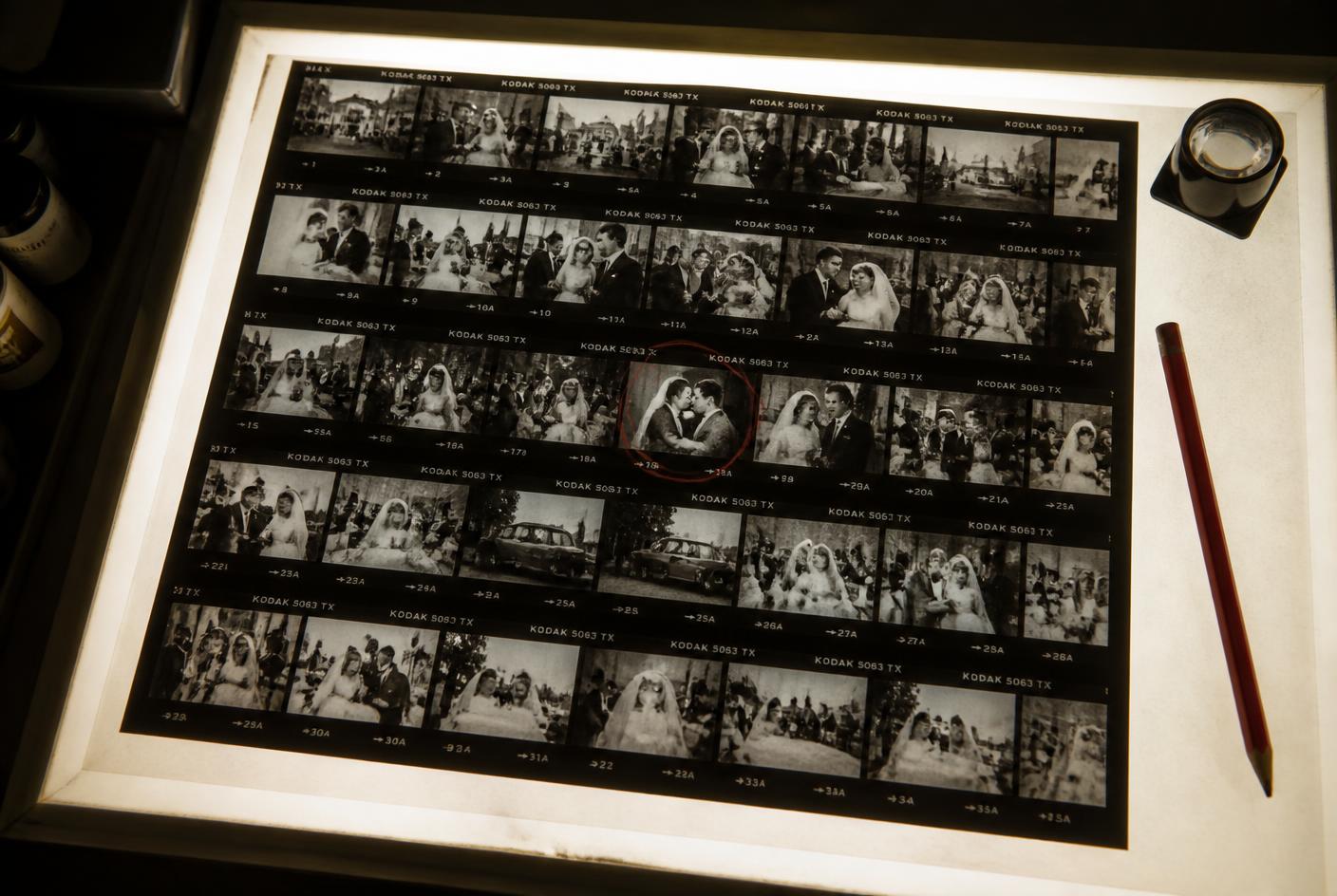 A contact sheet of wedding frames laid out on a lightbox